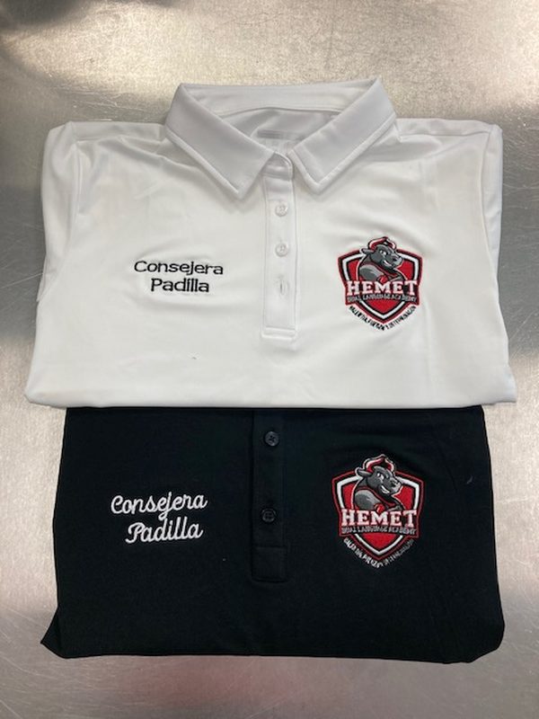 White and black polo shirts embroidered with the Hemet Unified School District crest and the name Consejera Padilla