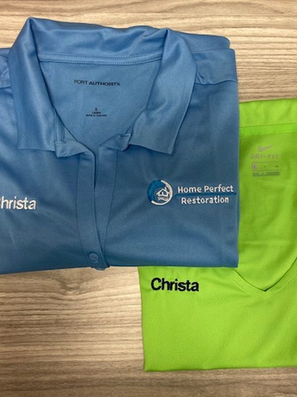 Light blue polo embroidered with the Home Perfect Restoration logo and the name Christa