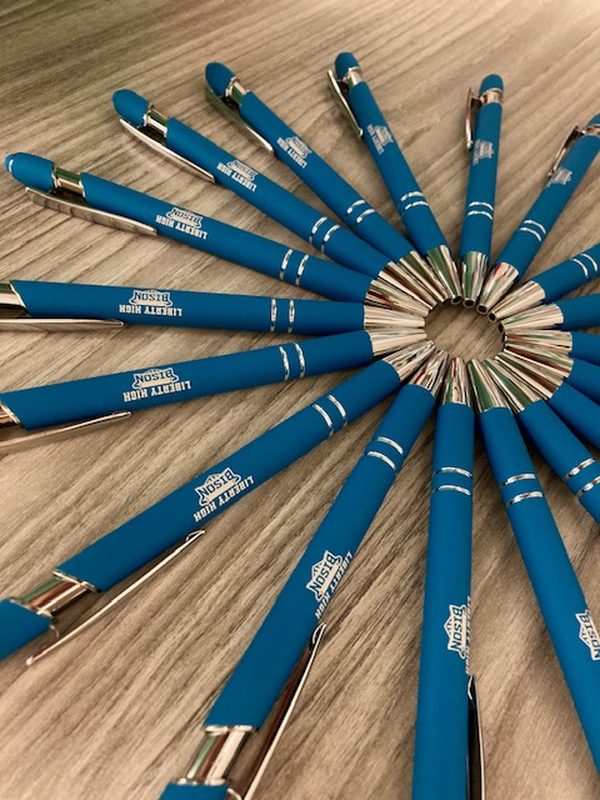 Blue pens printed with the Liberty High School logo, fanned into a circle
