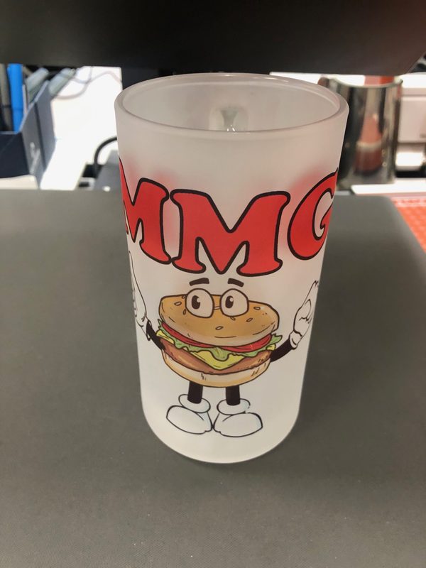 Frosted plastic cup printed with the Mad Madeline’s Grill burger mascot