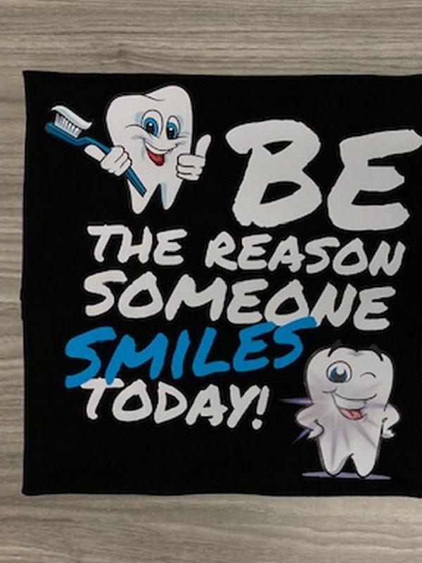 Black t-shirt printed with cartoon teeth and the slogan Be the reason someone smiles today, for Winchester Dental Group